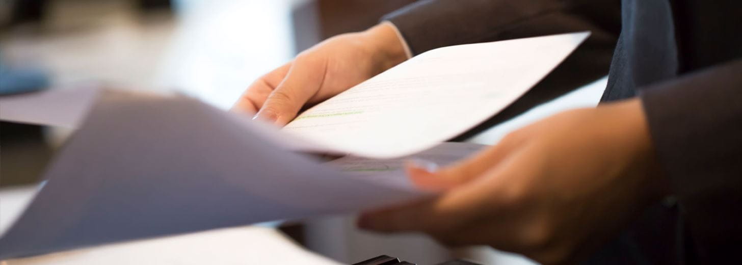 Man holding sheets of paper